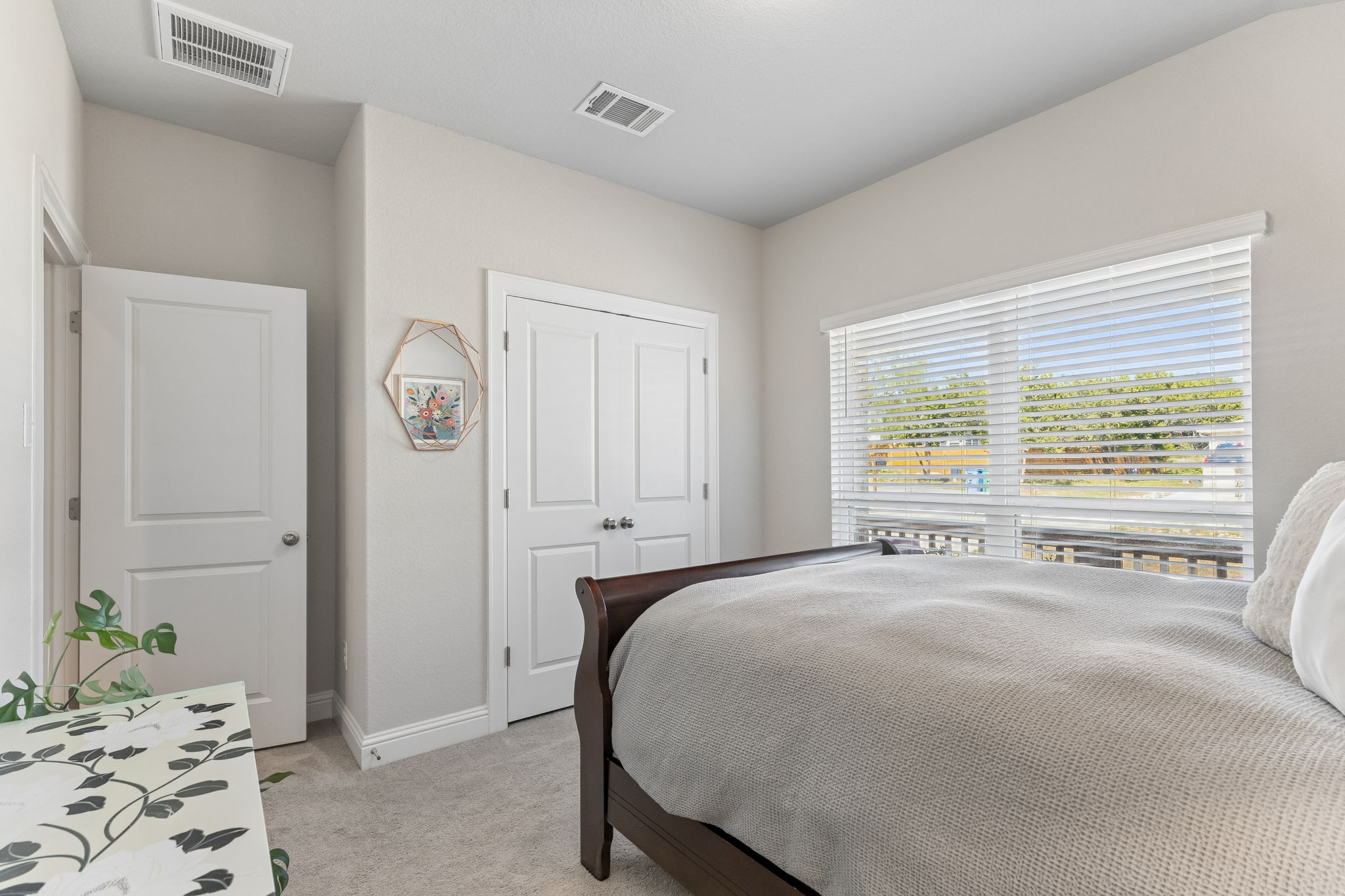 Bedroom with double-door closet and window blinds