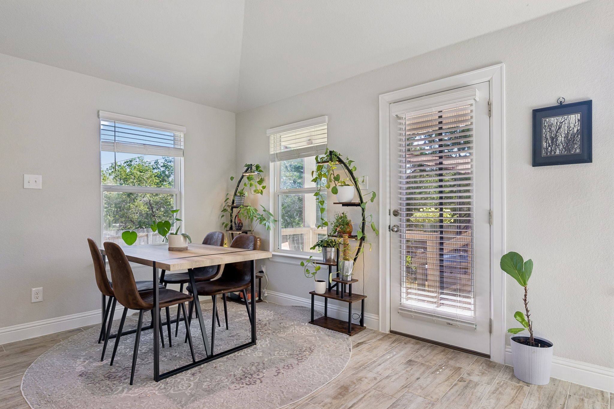 Open living area with breakfast bar and backyard access