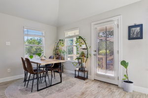Open living area with breakfast bar and backyard access