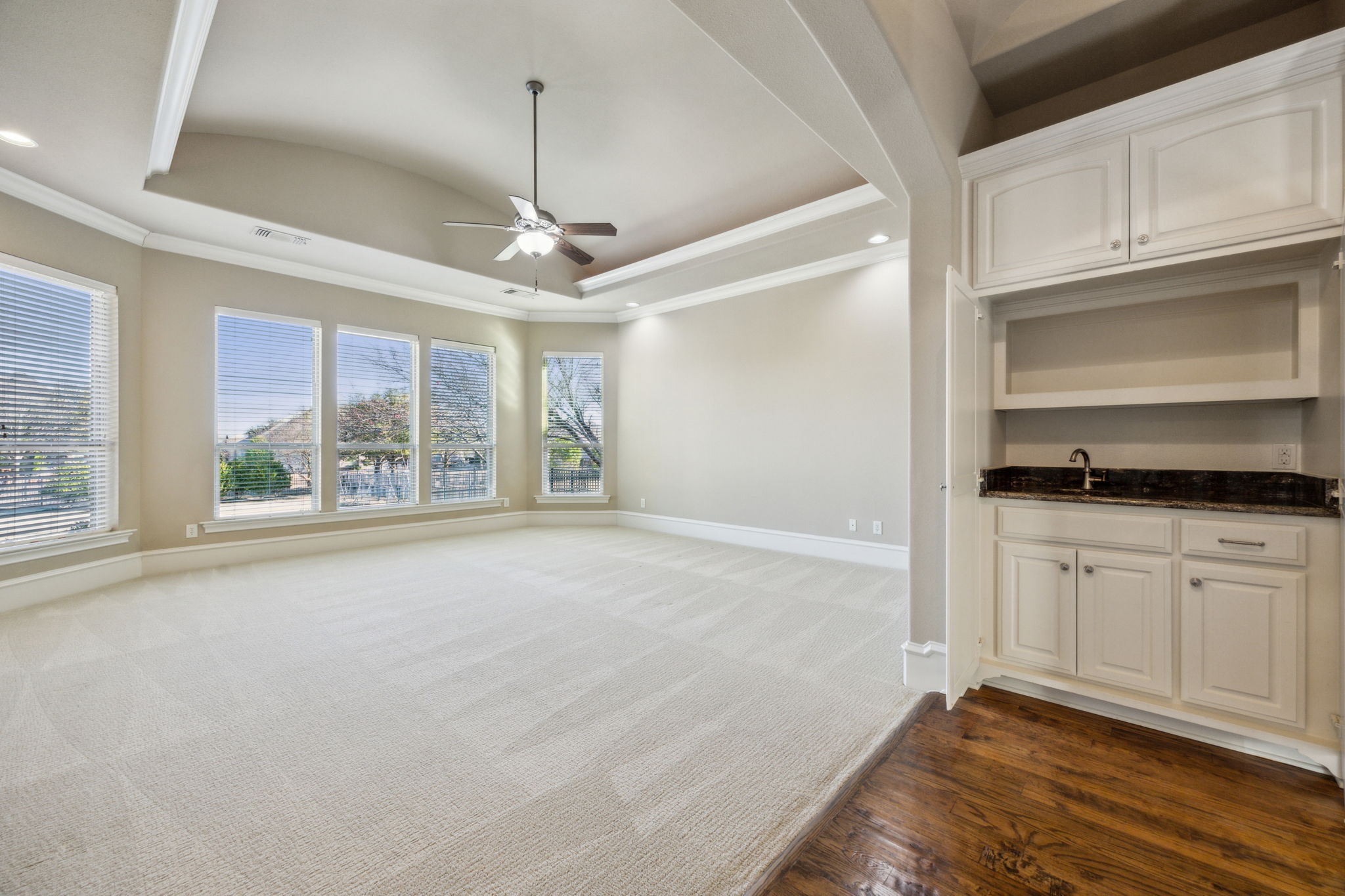 Large primary suite featuring a wet bar and storage