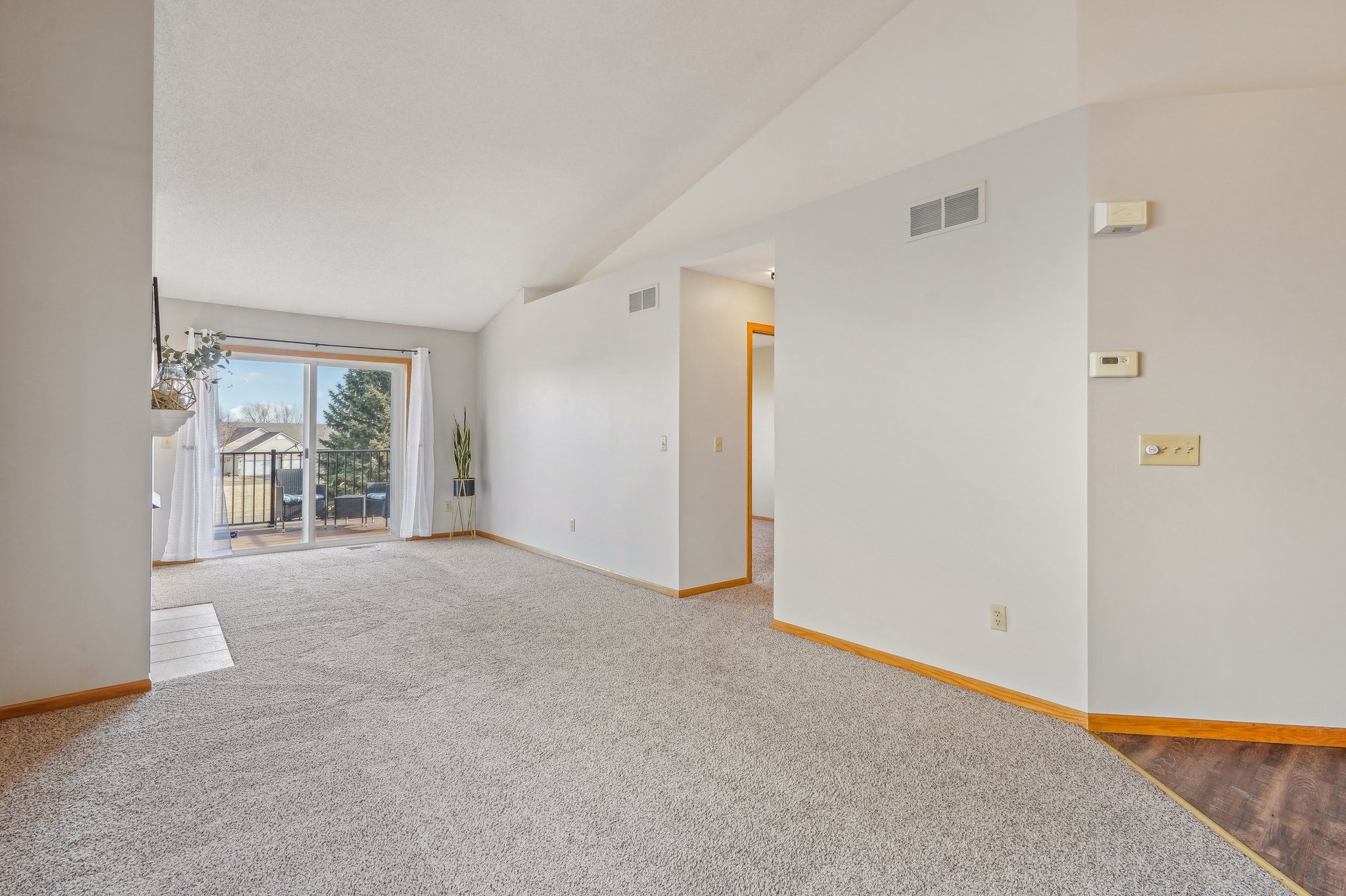 View from the Dining Area to the Deck and entry to the Owners Bedroom and Full Bathroom.