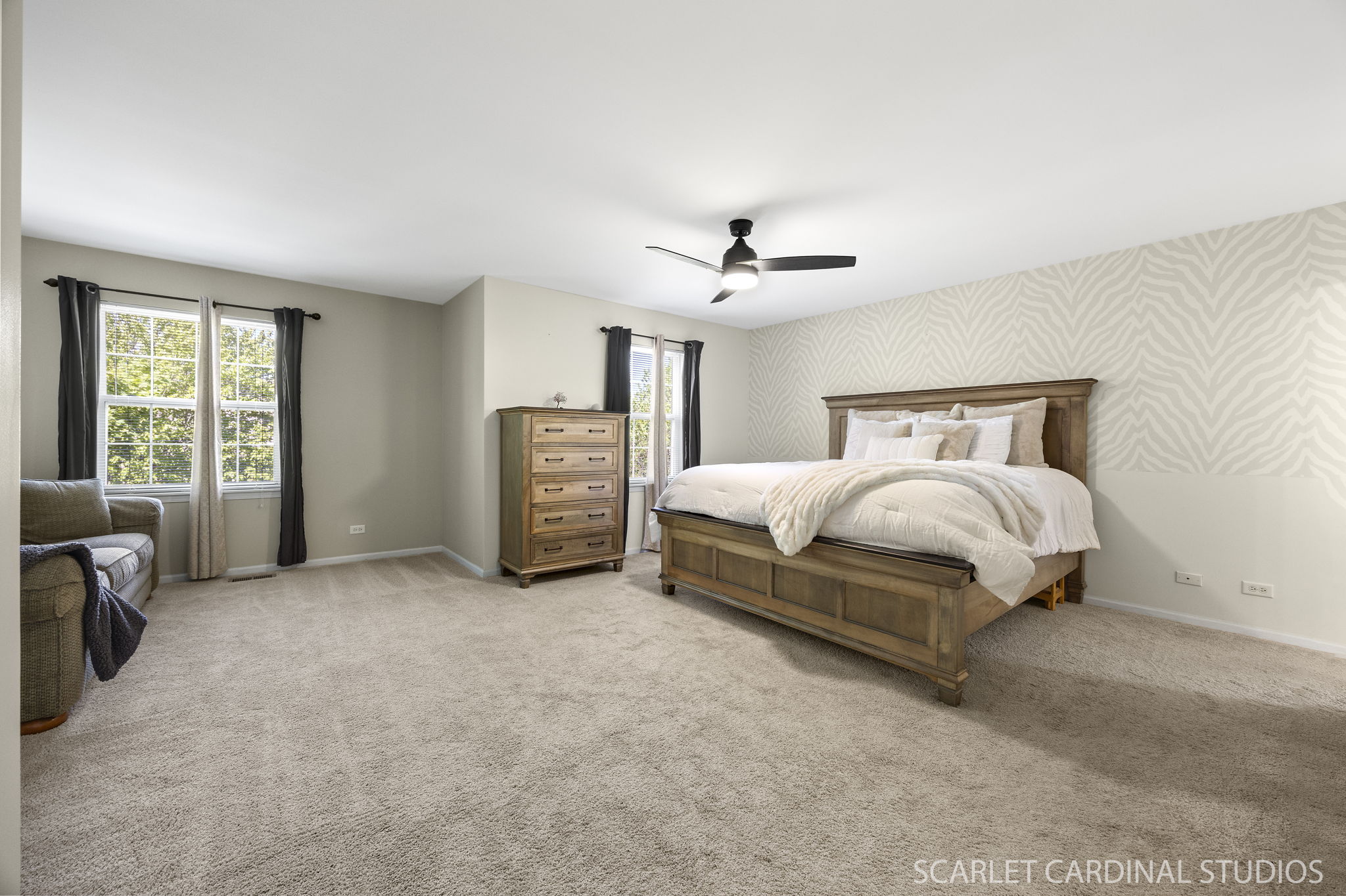 Impressively large primary suite with dedicated sitting area, generous walk-in closet, and a private en suite bath