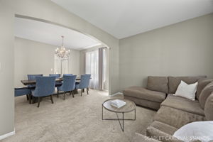 An elegant archway adds character while connecting the living and dining rooms
