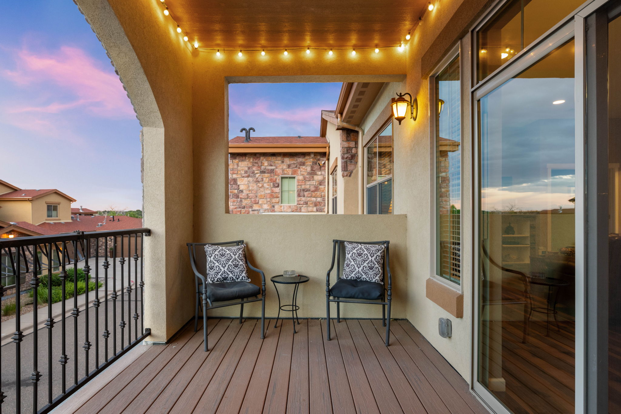 Covered patio with trex deck and wrought iron railing
