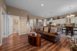 View from family room back into kitchen with 1/2 bath on left side