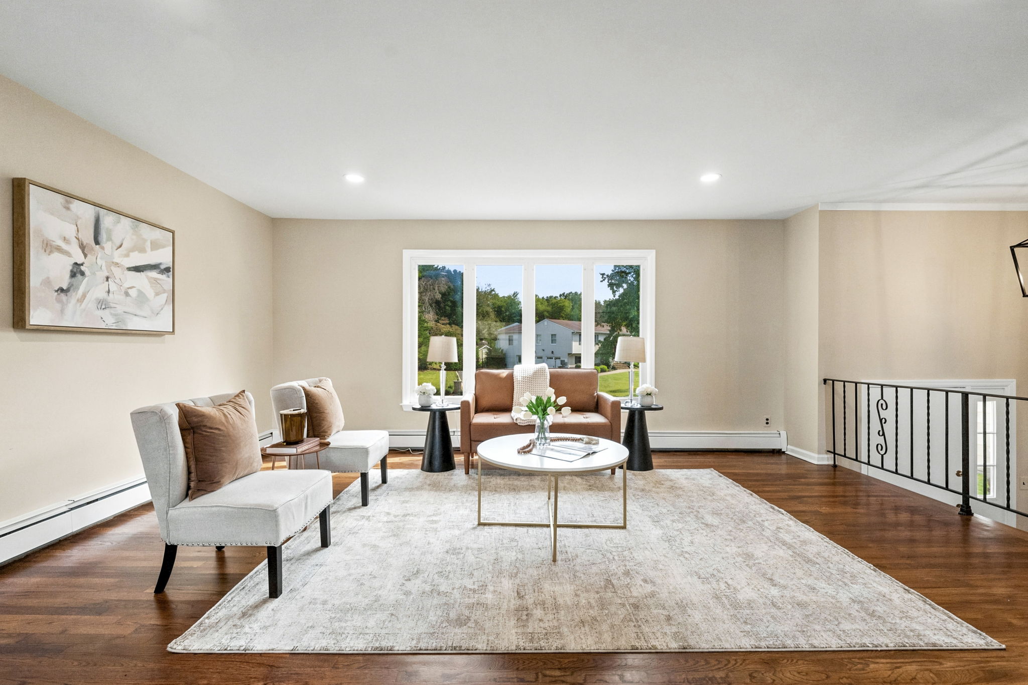 Spacious Living room; freshly painted, beautiful hardwood floors and open concept living.