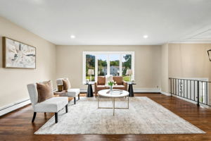Spacious Living room; freshly painted, beautiful hardwood floors and open concept living.