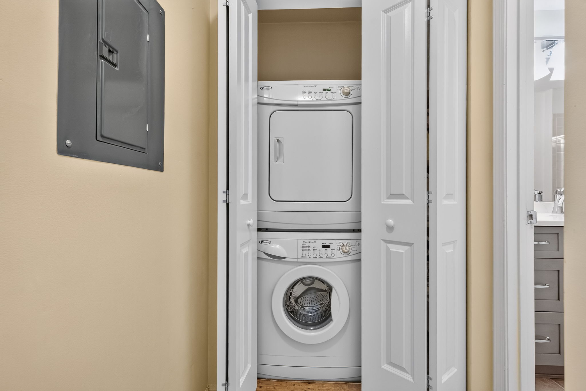 LAUNDRY CLOSET In-unit laundry with stackable Maytag washer and dryer adds everyday convenience.