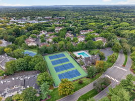 COMMUNITY PICTURE Residents of The Hills enjoy an array of amenities including a pool, tennis courts, clubhouse and fitness center, all within a beautifully maintained community setting.
