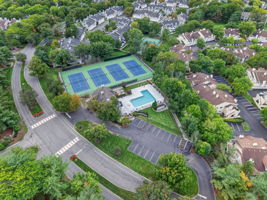 COMMUNITY PICTURE Residents of The Hills enjoy an array of amenities including a pool, tennis courts, clubhouse and fitness center, all within a beautifully maintained community setting.