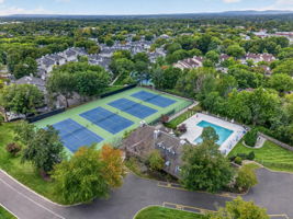 COMMUNITY PICTURE Residents of The Hills enjoy an array of amenities including a pool, tennis courts, clubhouse and fitness center, all within a beautifully maintained community setting.