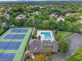 COMMUNITY PICTURE Residents of The Hills enjoy an array of amenities including a pool, tennis courts, clubhouse and fitness center, all within a beautifully maintained community setting.
