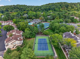 COMMUNITY PICTURE Residents of The Hills enjoy an array of amenities including a pool, tennis courts, clubhouse and fitness center, all within a beautifully maintained community setting.