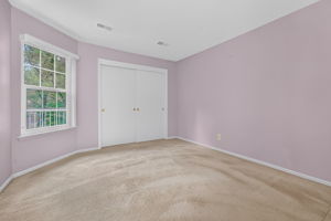 1st FLOOR BEDROOM Double doors open to the first-floor bedroom with a double slider door closet and wall-to-wall carpet.
