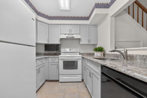 KITCHEN The tastefully renovated kitchen features Shaker cabinetry, granite countertops and ceramic tile flooring.