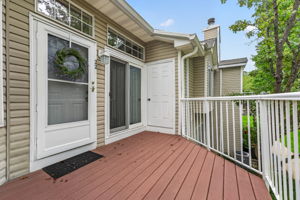 Glass slider leading to a private composite deck—an inviting spot for morning coffee and relaxation. Deck access to a convenient storage closet.
