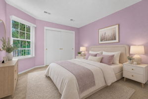 1st FLOOR BEDROOM Virtually Staged-Double doors open to the first-floor bedroom with a double slider door closet and wall-to-wall carpet.