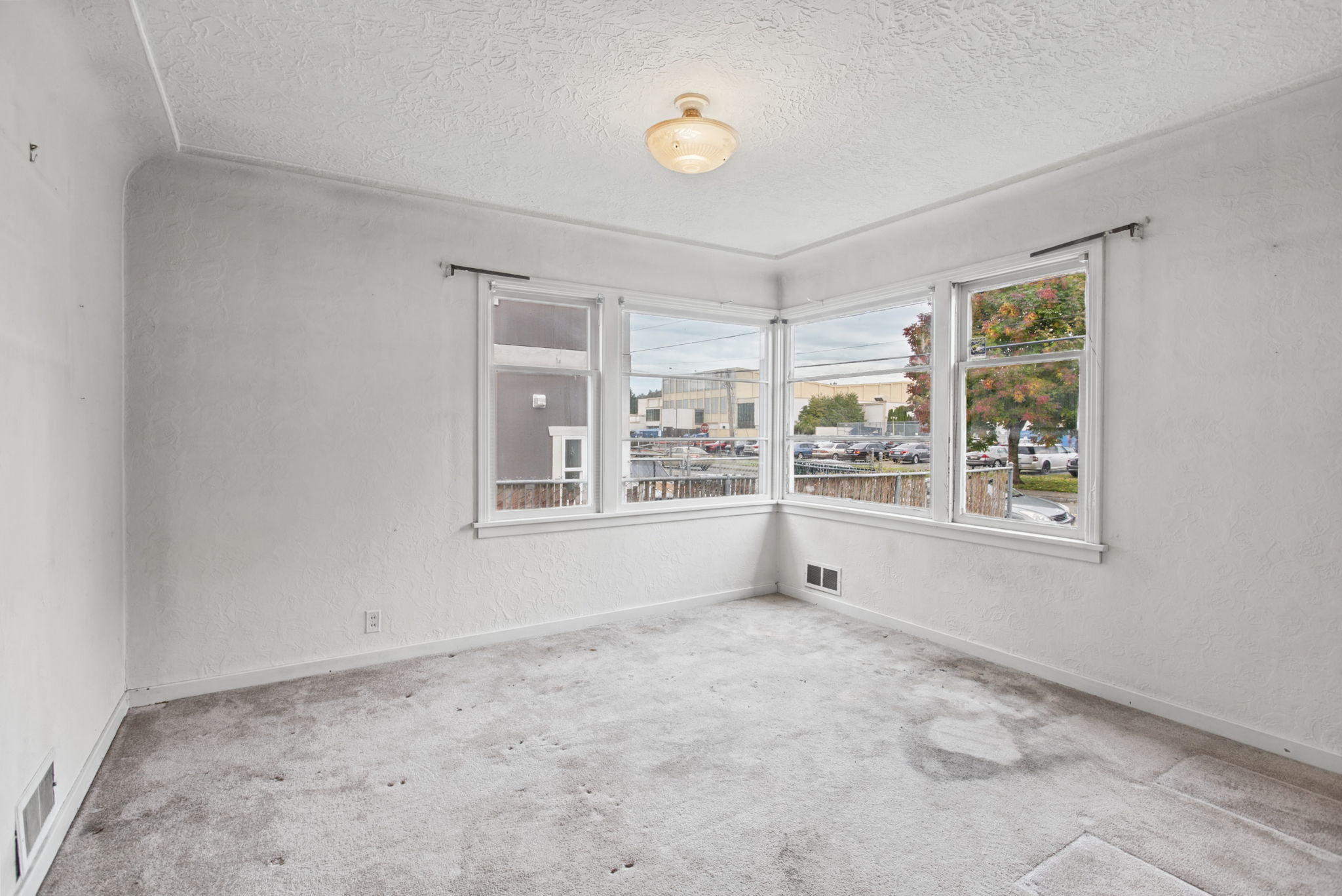 Classic 1940s corner windows bring natural light into the formal dining room.