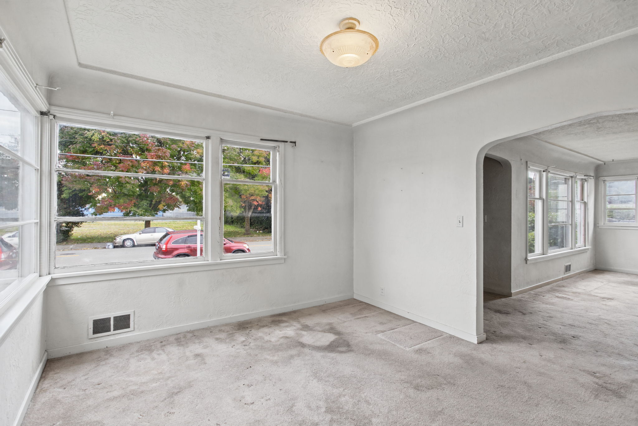 Wide dining-room view showing the arched connection to the living room.