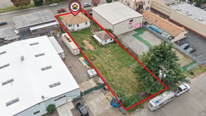 Reverse aerial view shows the parcel extending from S Tobin Street to rear alley access; approximate outline shown in red.