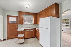 Kitchen view highlighting the cabinetry, work surfaces and connection to the dining room.