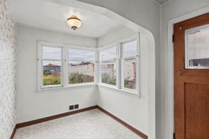 Bright breakfast nook framed by an arched opening off the kitchen.