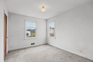 Main-floor bedroom with windows on two sides.