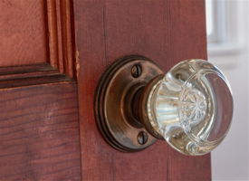 Vintage glass doorknob and paneled wood door — one of the home’s distinctive 1940s details.