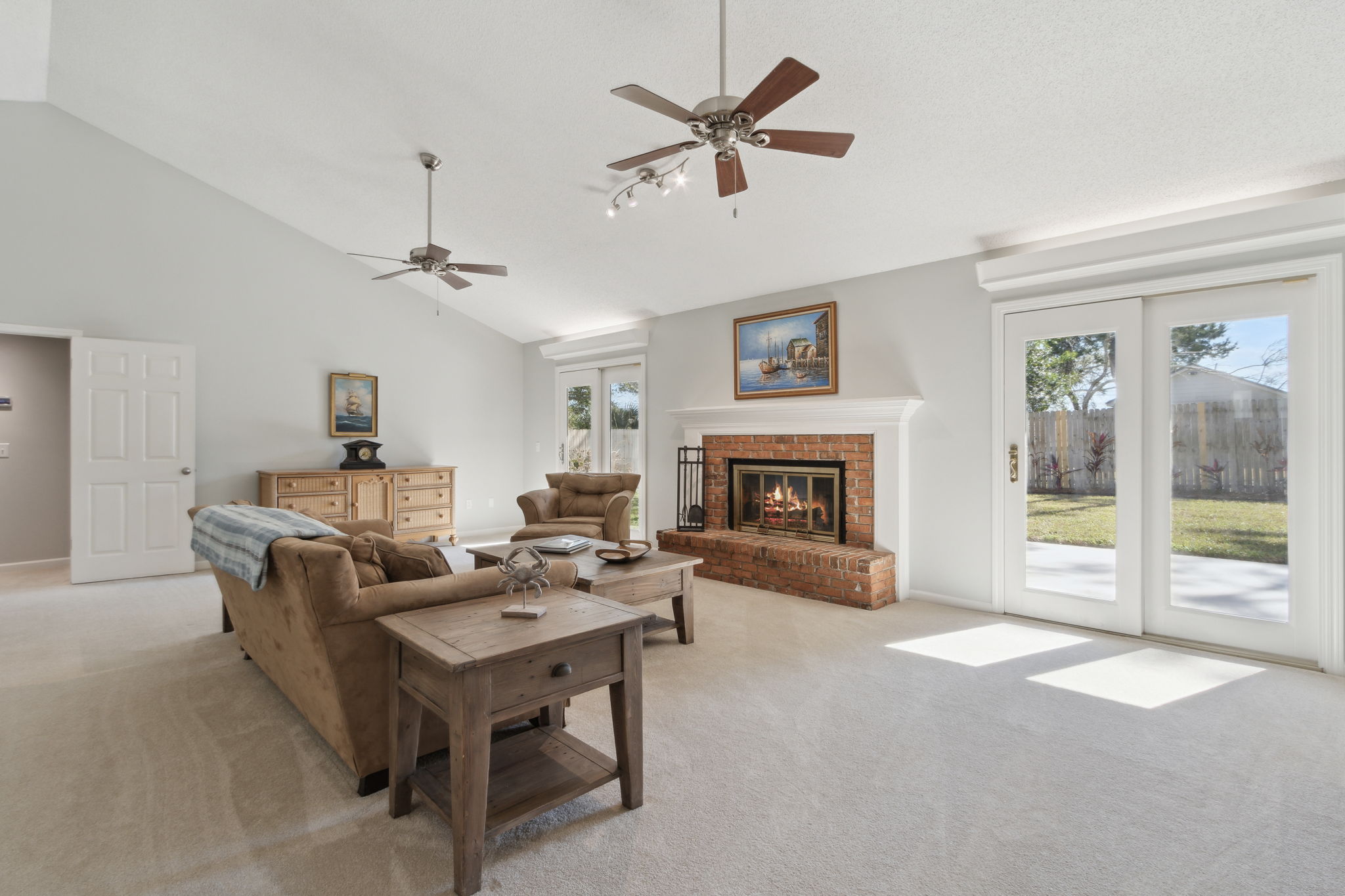 Great Room with Vaulted Ceiling, Wood burning fireplace and sliding doors to the patio and fenced backyard