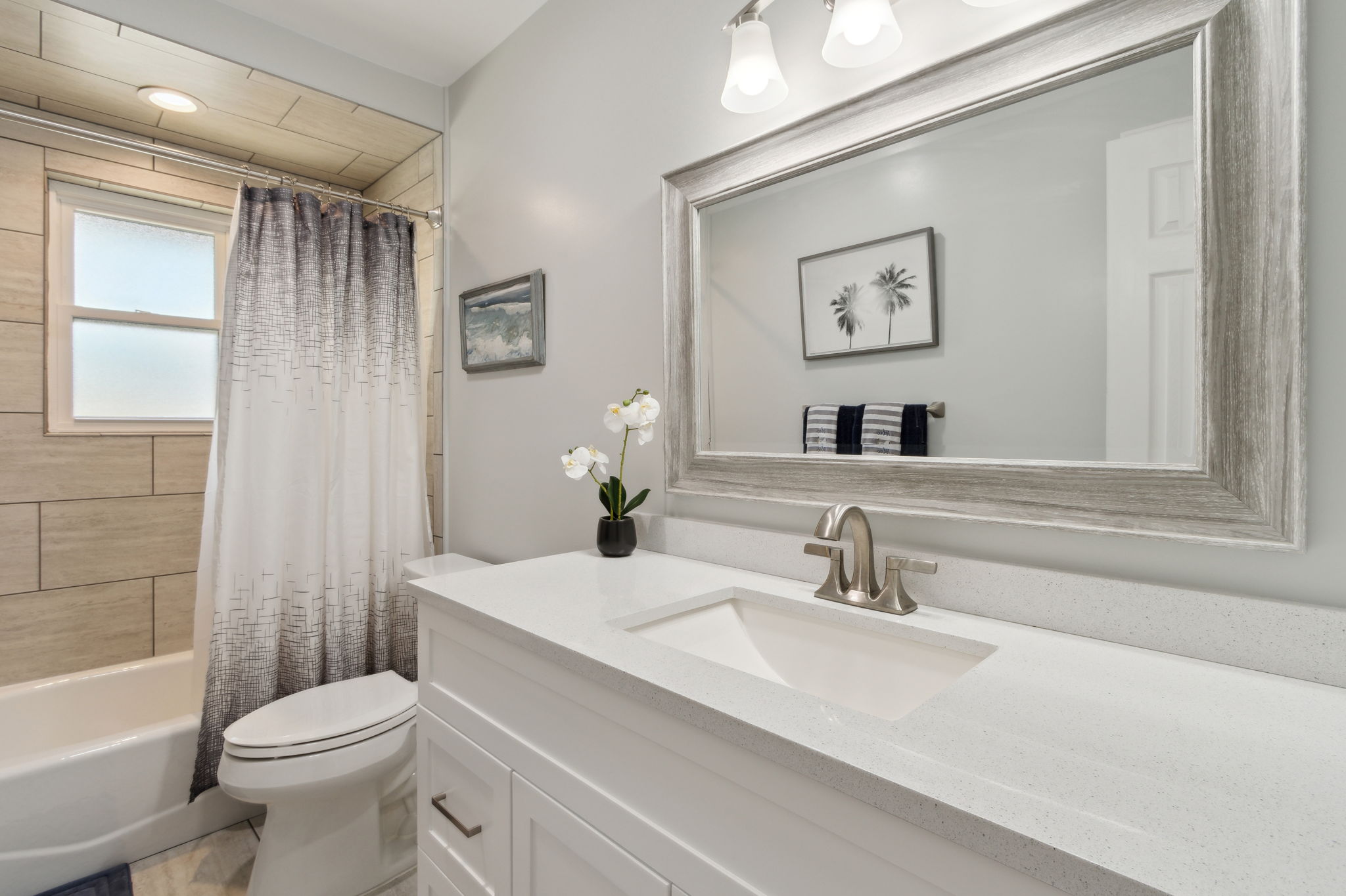 Bathroom 2 with combination shower/tub  and engineered stone countertops