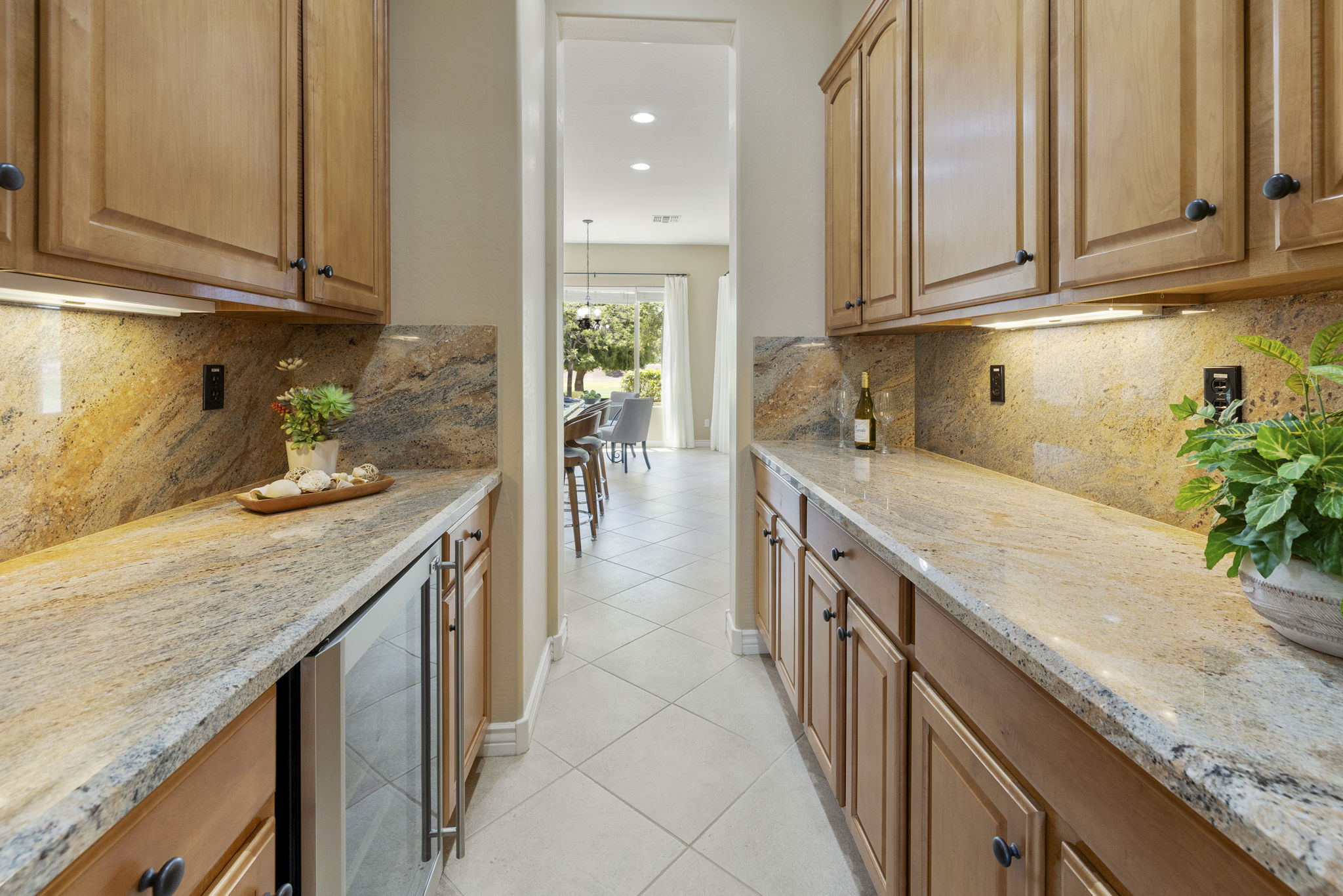 Butlers pantry provides storage for serving barware and serving pieces.