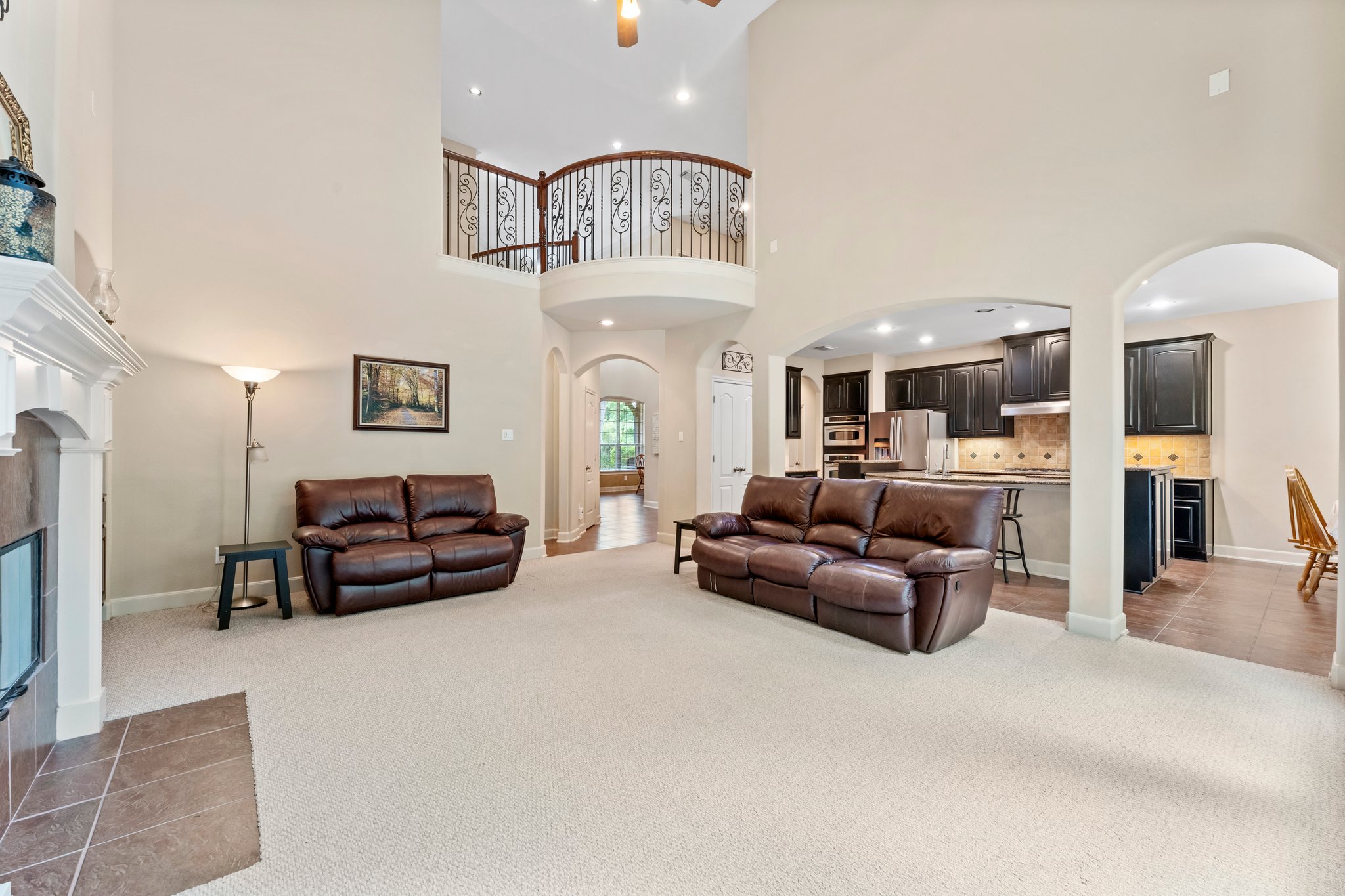 Family room is open to the kitchen and features large decorative arches.