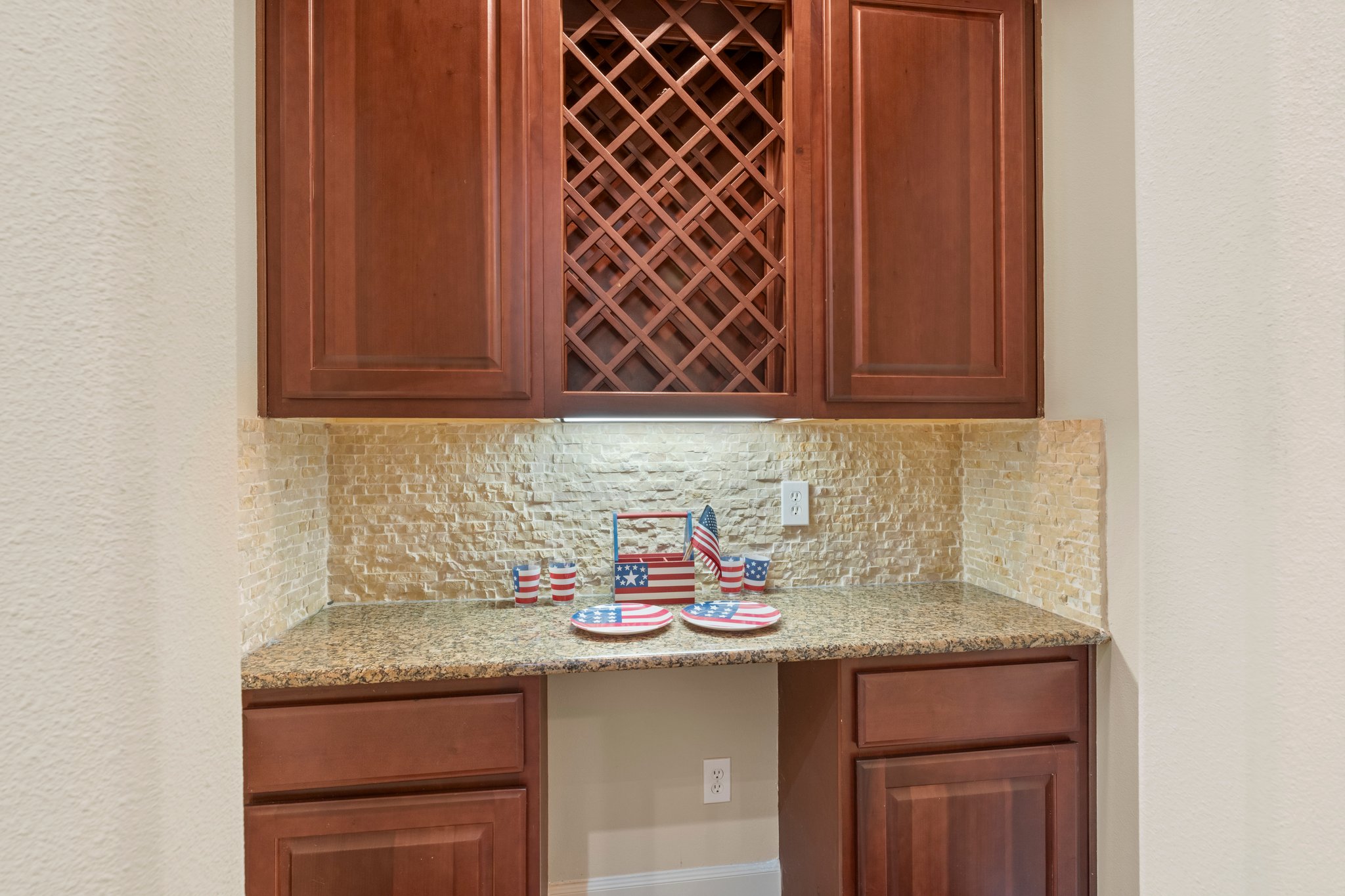 Butler’s Pantry off of entry way with wine rack, storage, granite countertop as well as space for mini frig.