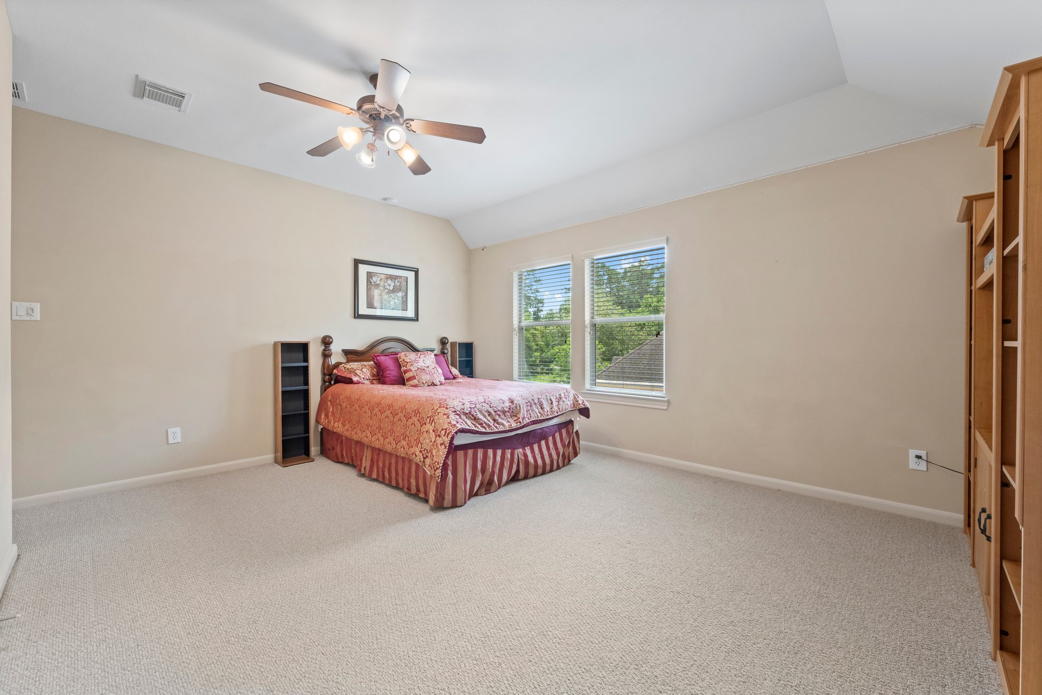 This large bedroom shows a queen bed and could easily be used as a media room.