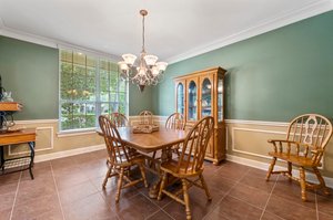 Dining room off of entry with large windows for plenty of natural light.
