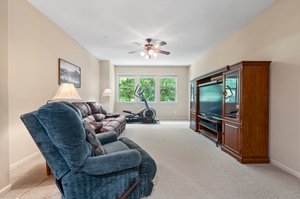 Upstairs game/family room has large windows overlooking the pool and backyard.