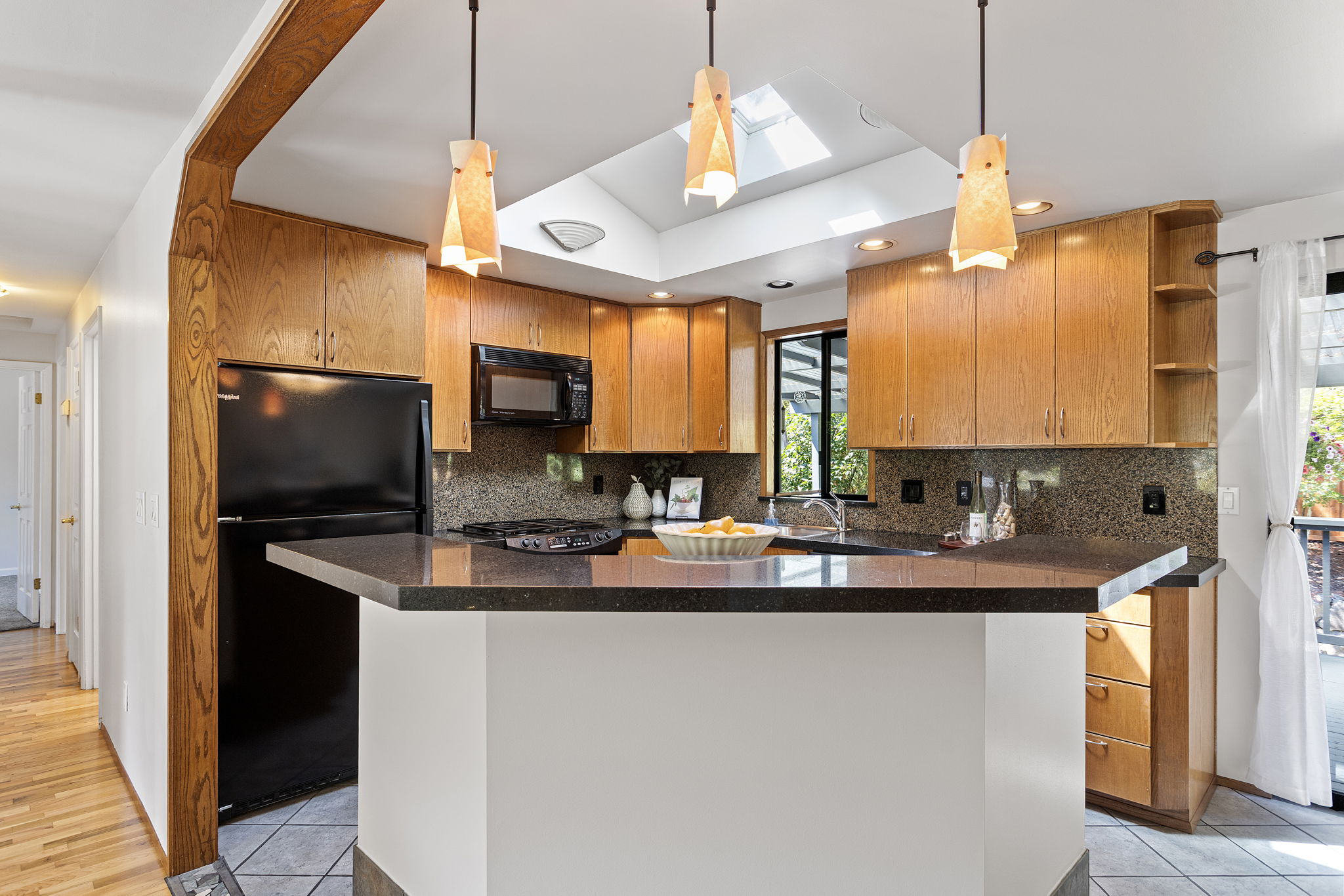 Kitchen and dining area with skylights