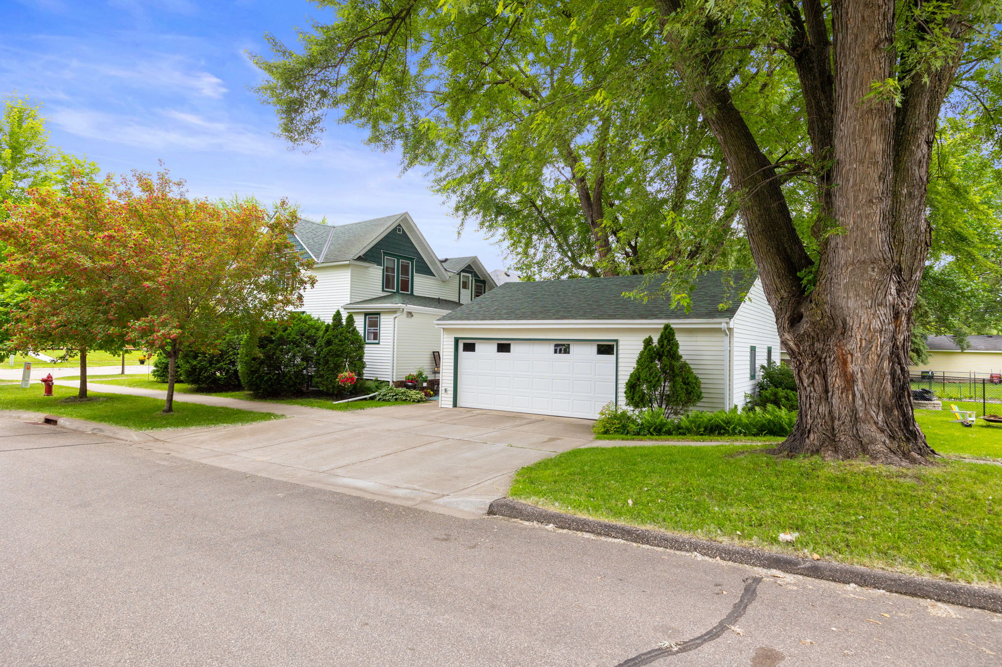 Oversized two-car garage with 16' door and plenty of room for storage and a work area. The wide concrete drive allows room for plenty of additional parking.