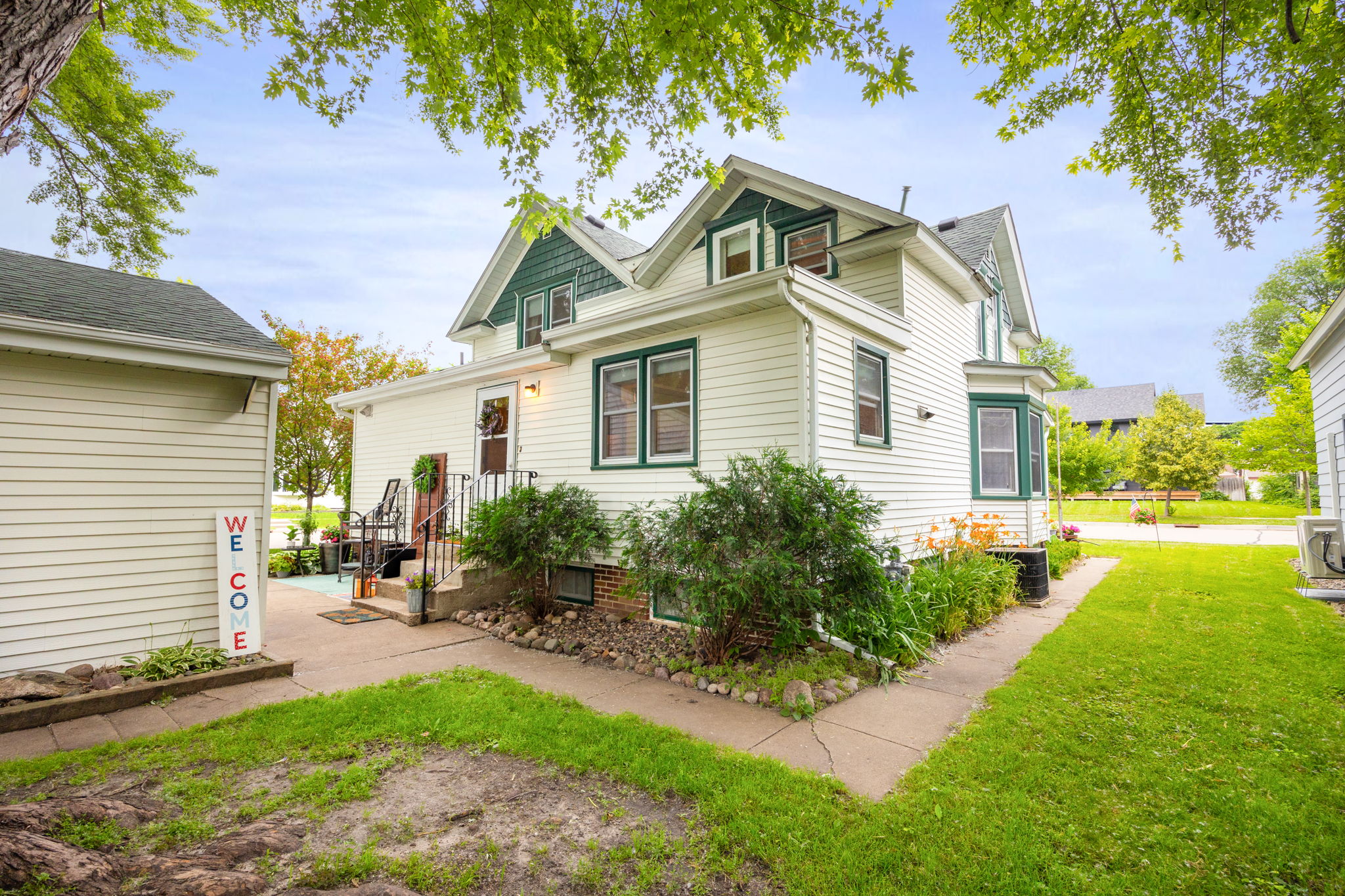 This home features a concrete walk around the entire home, a really nice feature. There are perennial lilies and Boston ferns around the house and beautiful trees throughout the property.