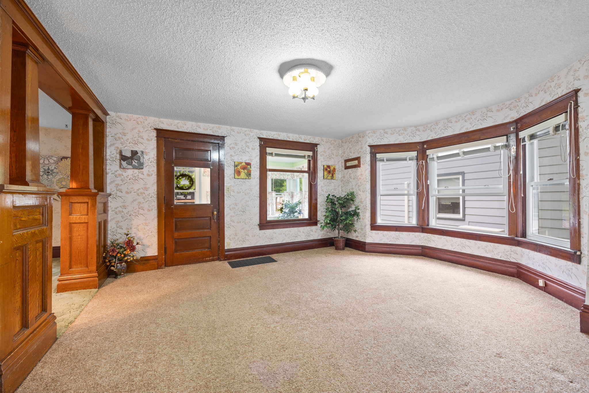Impeccable Arts and Crafts period finishes keep the amazing character of the home front and center! Formal living and dining rooms are separated by an impressive transition piece featuring columns and paneling.