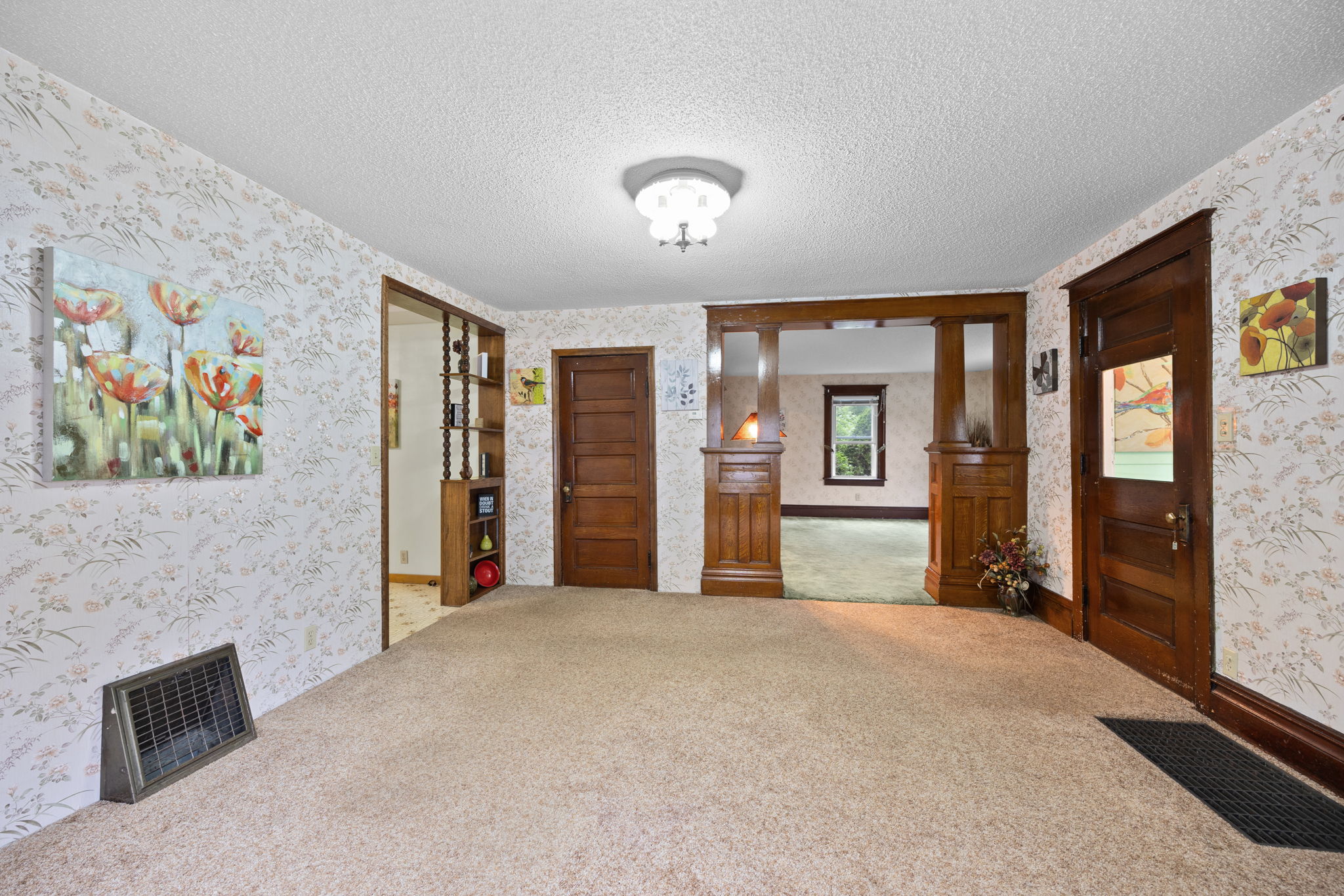 The paneled door leads to the upper level. This property was once a duplex so there is an oldfashioned skeleton key lock still in this door.