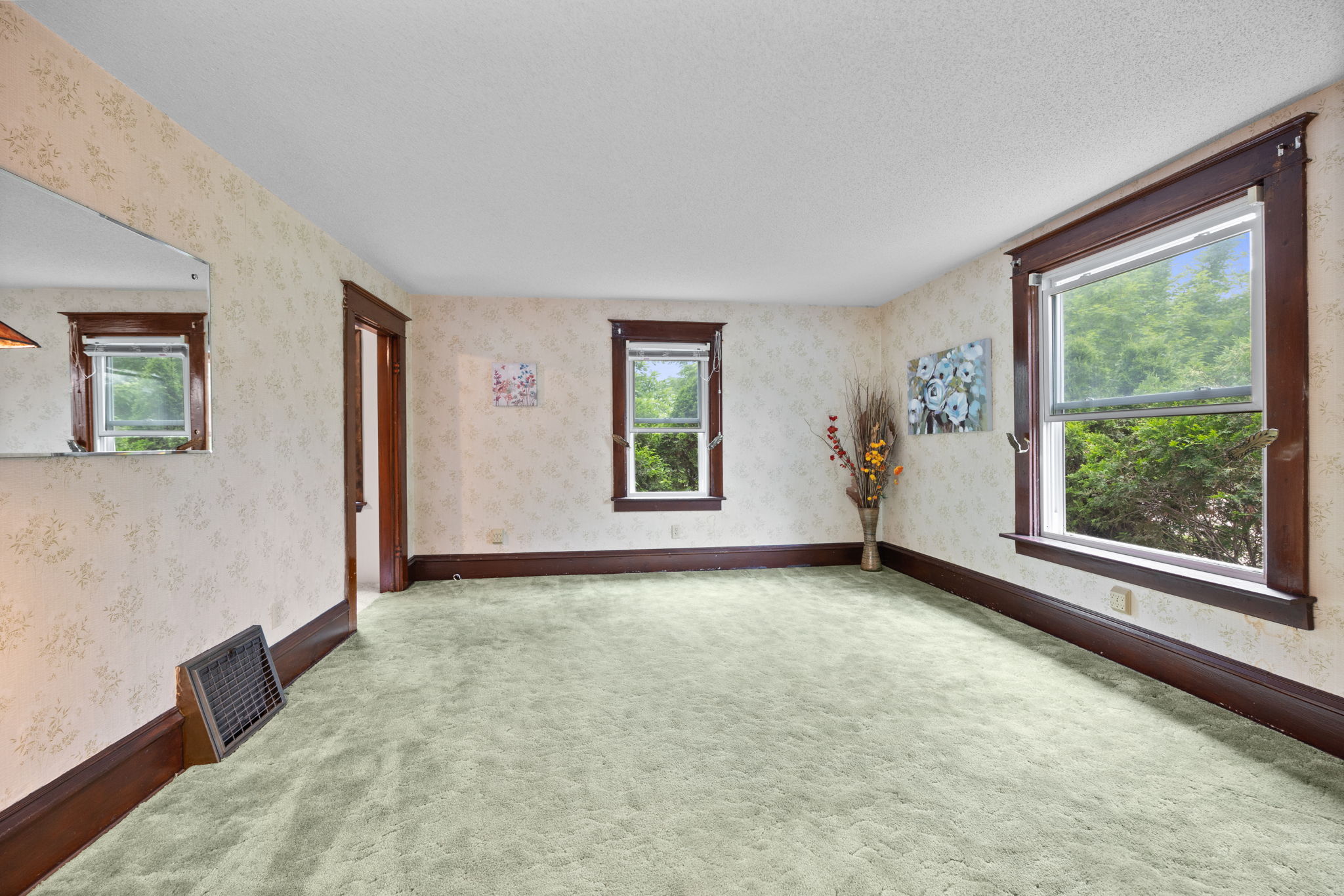 The room also features custom millwork from the period and oversized base moldings that boasts the original character of this 1913 era home.
