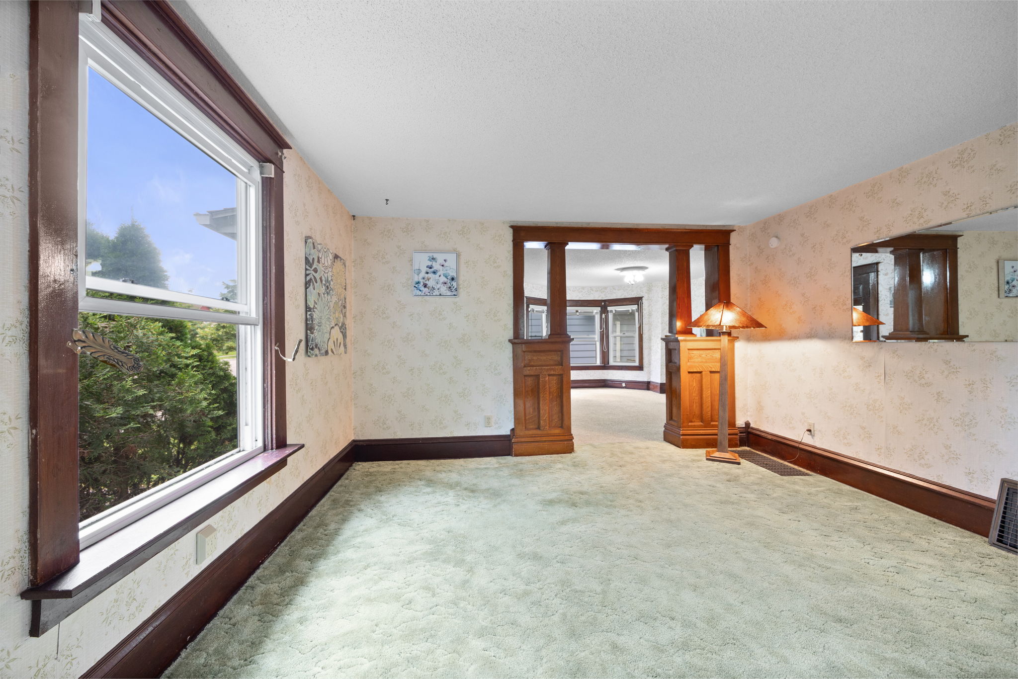 An abundance of over-sized windows allow natural light to flow through the home and showcase the dramatic, custom millwork that embodies the rich history of our area.