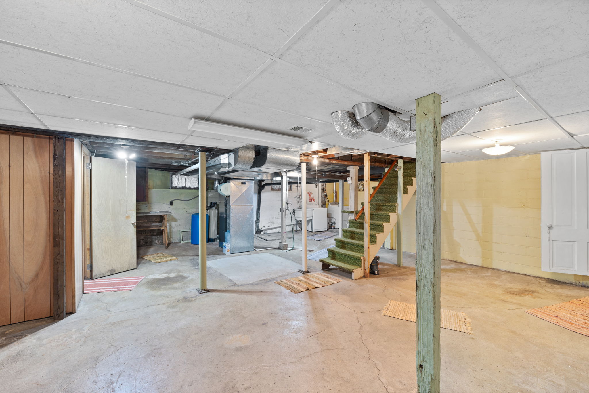 Unfinished full basement, concrete block with root cellar with shelving under front porch.