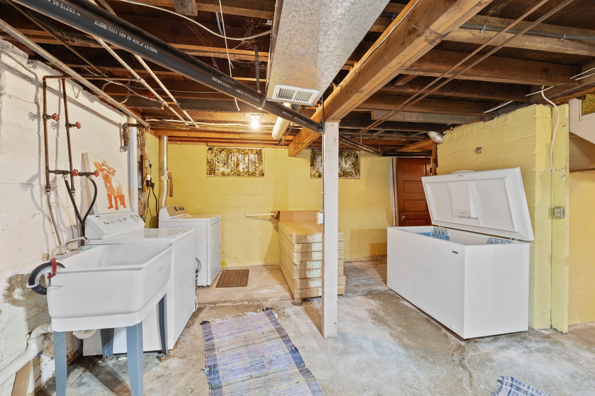 Washer and dryer with laundry sink and huge freezer that stays with the home. Additional ceiling tiles and rails are located in the home along with original doors that were removed from the upper levels.Washer and dryer with laundry sink and huge freezer that stays with the home. Additional ceiling tiles and rails are located in the home along with original doors that were removed from