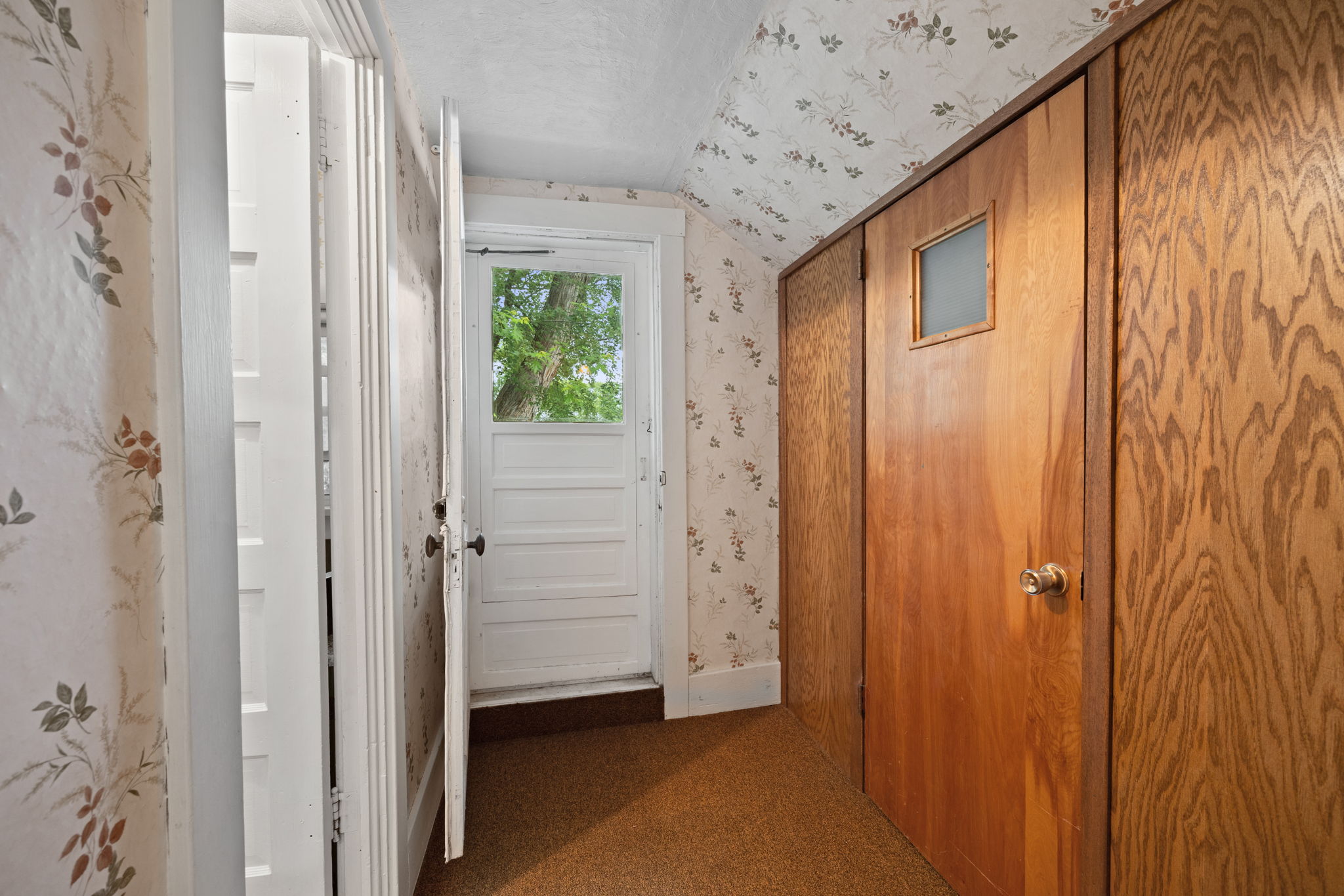 A 2nd large storage closet is located across from the bath. The white door leads to a the flat roof above the kitchen that could be competed to be used as a balcony. When this property was a duplex this was the entrance to the upper level unit.