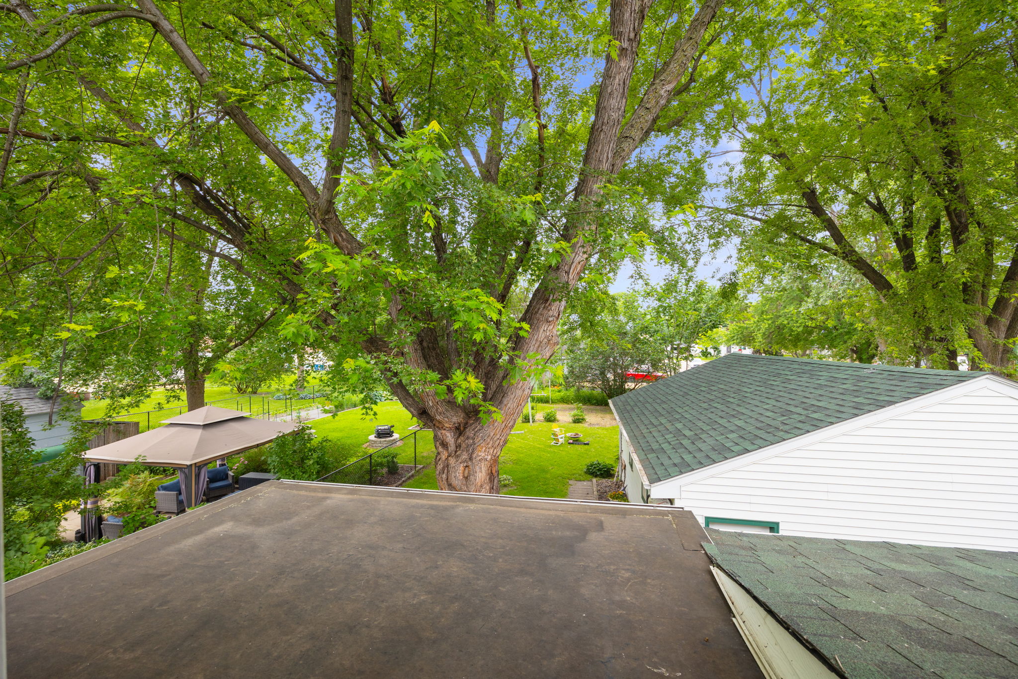 The view from the flat roof above the ktichenj(future upper level balcony area) to the backyard. This area is accessed from a door just outside the upper level bath.