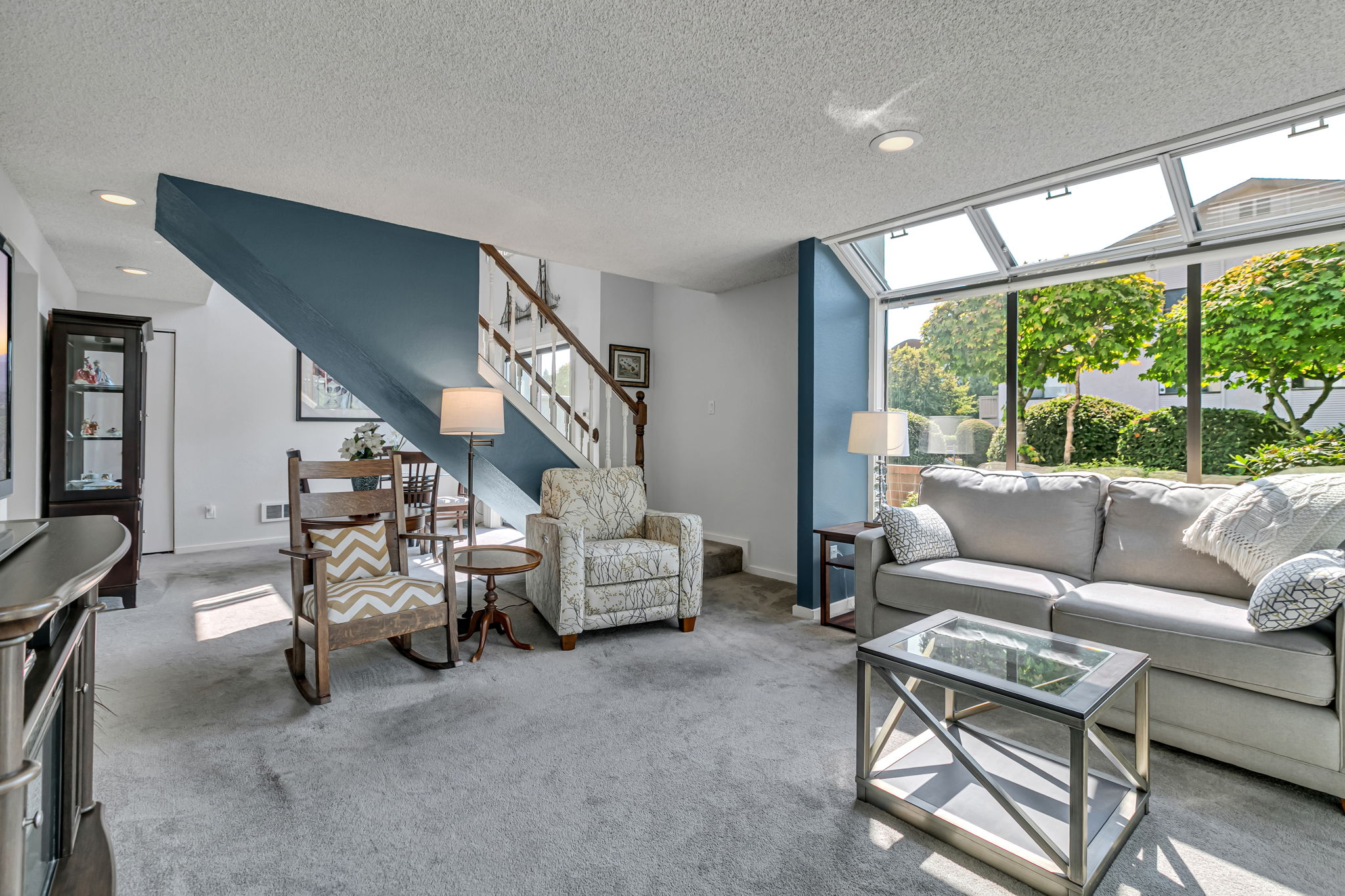 Abundant windows fill the spacious living room with natural light.