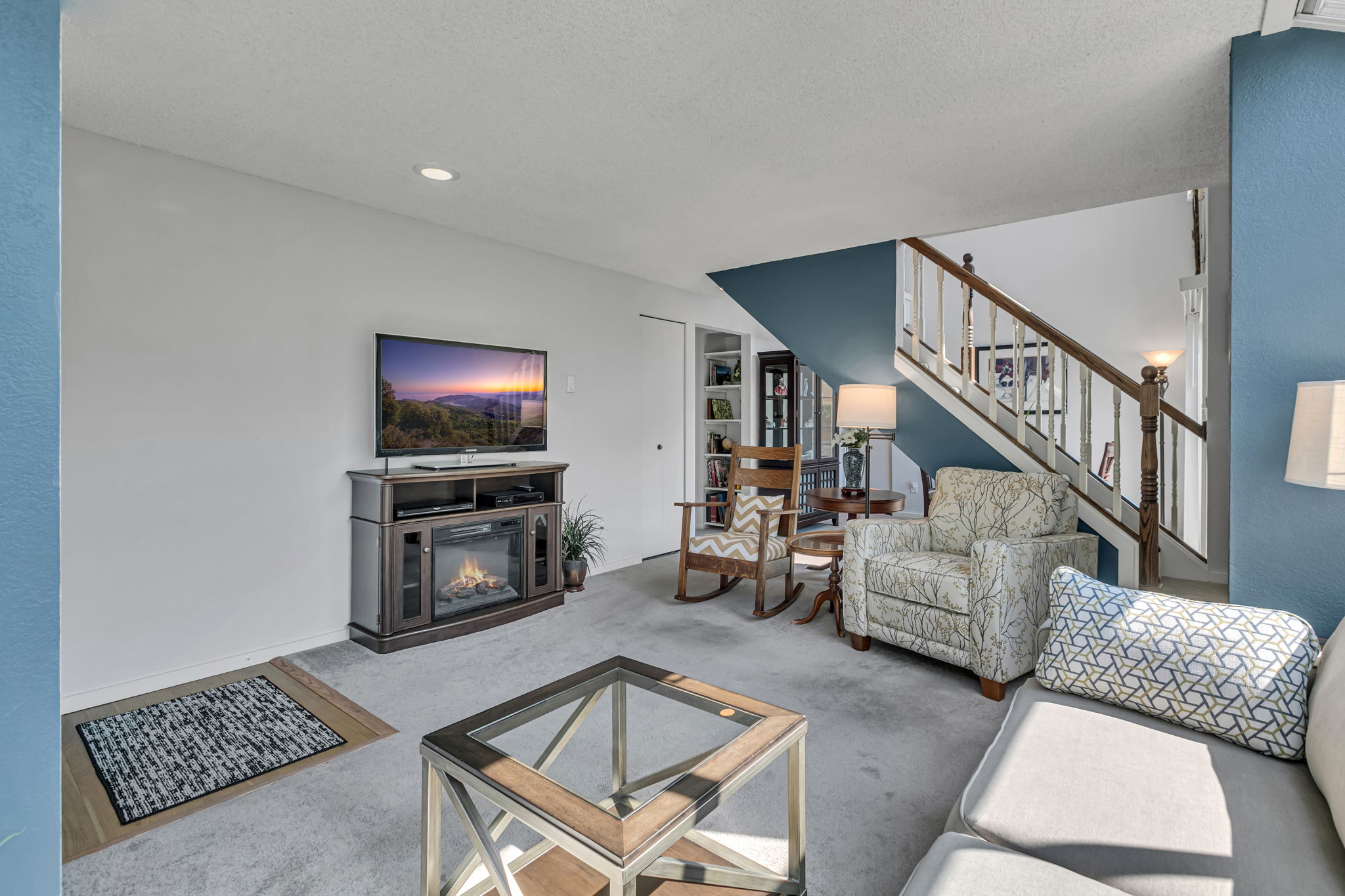 Spacious living room with an open connection to the dining area and staircase.