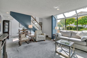 Abundant windows fill the spacious living room with natural light.